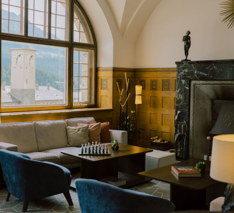 Großzügiger Wohnzimmer Bereich mit Kaminfeuer, Teesorten, großem Fenster mit Blick auf den See.